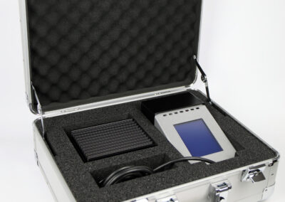 TIR100-2 portable emissometer and calibration standard packed inside their protective aluminium transport case.