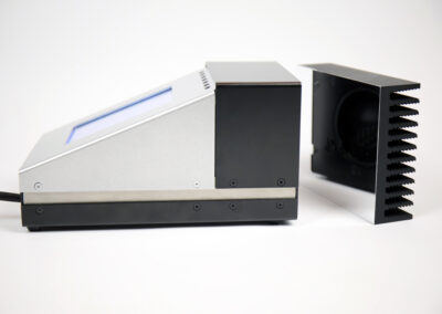 Side view of the TIR100-2 emissometer next to its PTB-traceable calibration standard for accurate emissivity measurement.