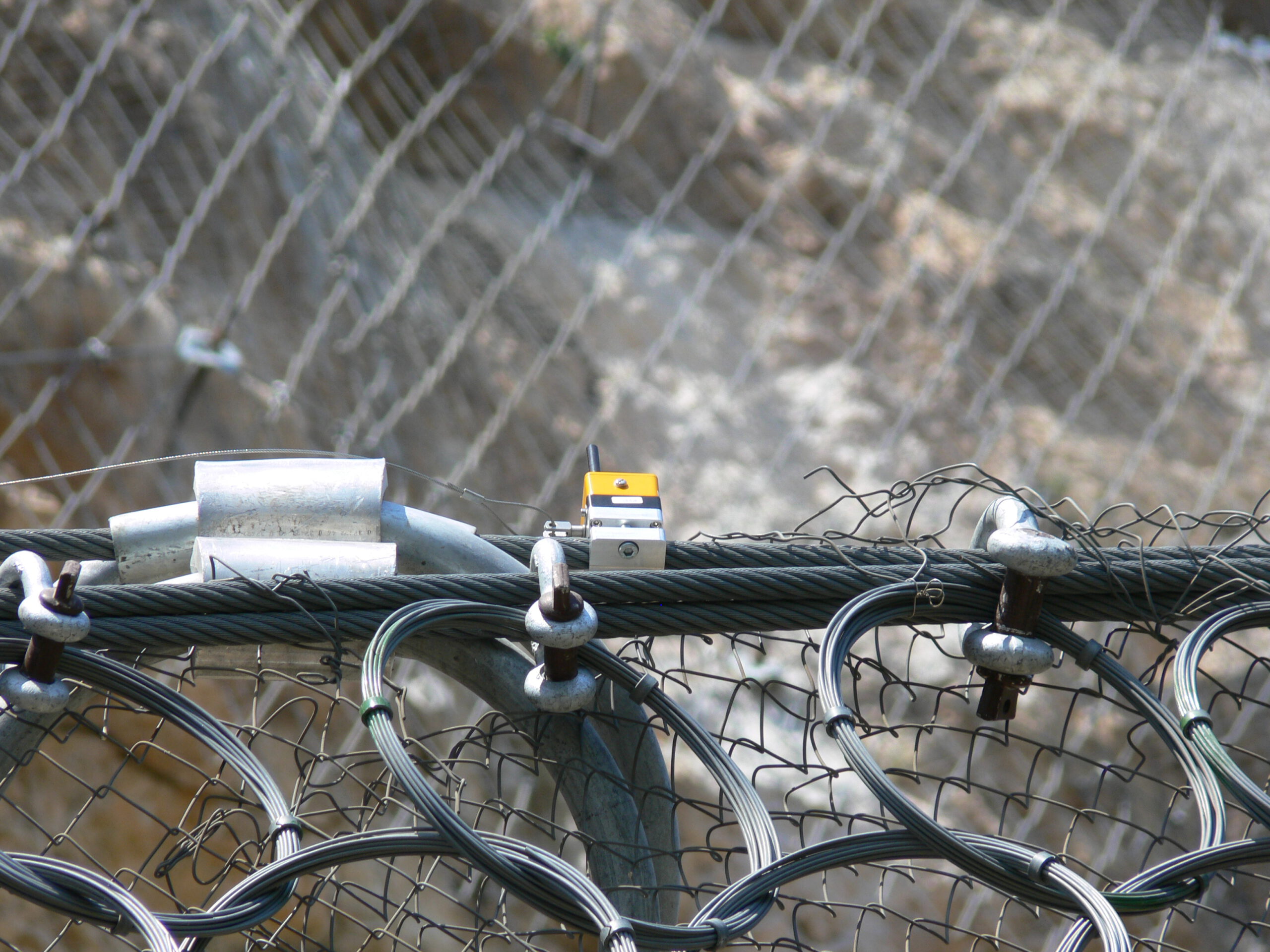 ImpactSentinel sensor mounted directly onto an existing rockfall barrier